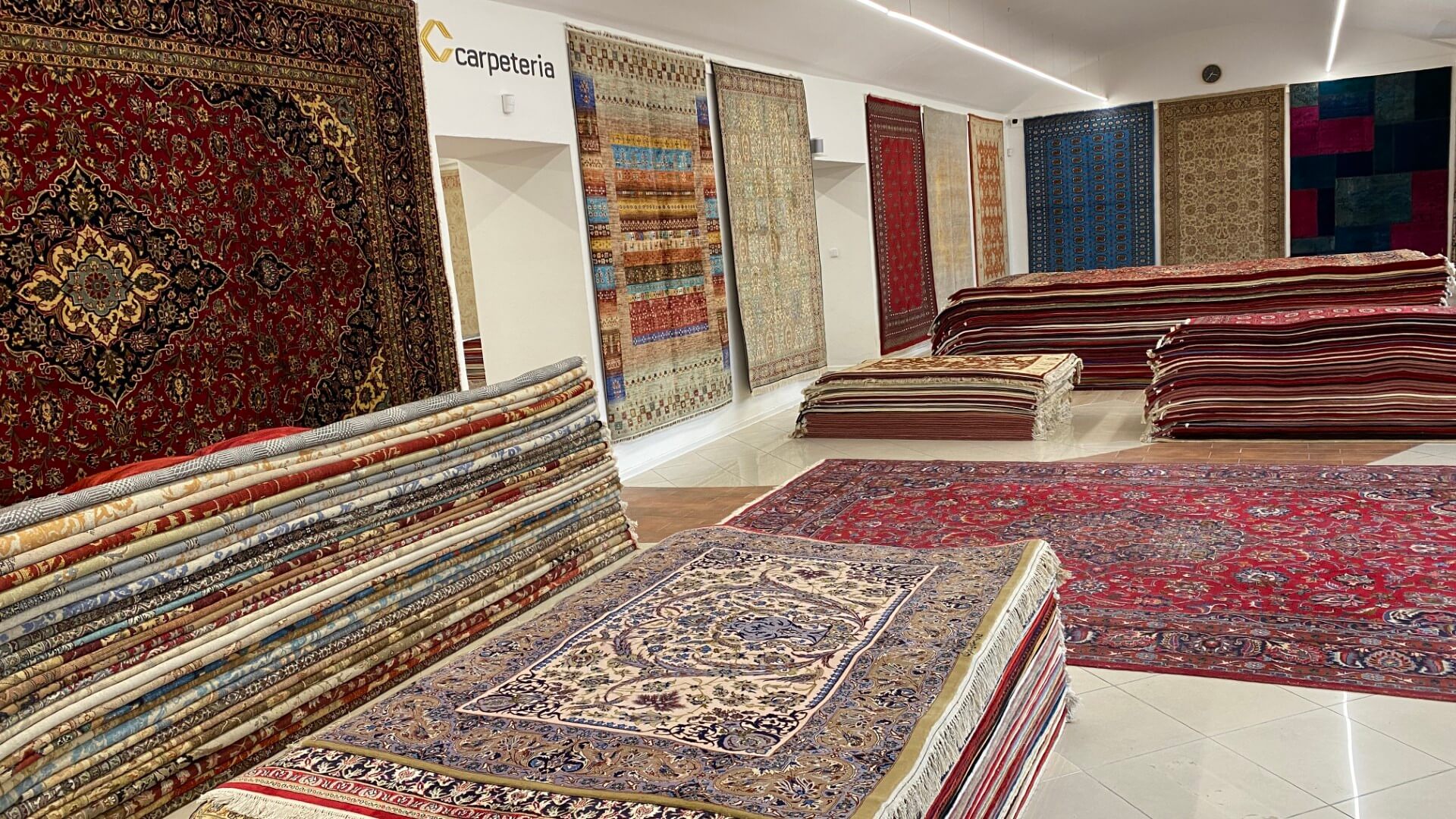 Rows of hand-knotted rugs ready to be opened out and compared in the showroom